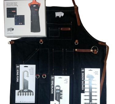 A BBQ gift set including three stainless steel tools: a meat shredder, grill scraper, and skewer, along with a black BBQ apron, all neatly arranged.