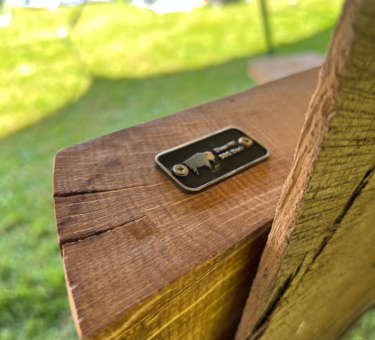 Close-up of Bison Hill BBQ Block product tag on the side of a handcrafted English Oak chopping board