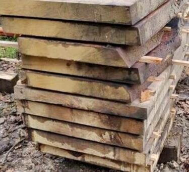 Stack of freshly cut wooden planks.