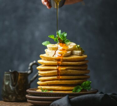 Beef skewers cooking over an open charcoal fire in the Espetada style